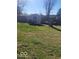 Backyard featuring a shed, mature trees, and green lawn at 4930 Candy Spots Dr, Indianapolis, IN 46237