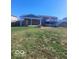 Large backyard featuring a covered patio, fire pit, and stairs to an upper level deck at 4930 Candy Spots Dr, Indianapolis, IN 46237