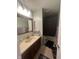 The bathroom features a granite-style sink top and vanity, a decorative mirror and a shower/tub at 4930 Candy Spots Dr, Indianapolis, IN 46237