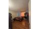 Comfortable bedroom with wood floors and natural light coming through the plaid-patterned window at 4930 Candy Spots Dr, Indianapolis, IN 46237