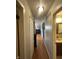 Hallway featuring hardwood floors leading to a bathroom and living area at 4930 Candy Spots Dr, Indianapolis, IN 46237