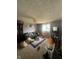 Spacious living room with a sofa, patterned area rug, and a large window for natural light at 4930 Candy Spots Dr, Indianapolis, IN 46237