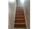 Stairway featuring wooden steps, painted walls, and a wooden handrail for added safety at 4930 Candy Spots Dr, Indianapolis, IN 46237