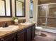 Bathroom with a dual sink vanity and tiled shower at 5010 S 550 W, Columbus, IN 47201