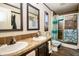 Well-lit bathroom with a double sink vanity, granite countertop, and modern shower, designed for convenience and style at 5010 S 550 W, Columbus, IN 47201