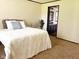 Comfortable bedroom with carpeted floors and view to full bath at 5010 S 550 W, Columbus, IN 47201