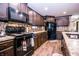 Modern kitchen featuring sleek appliances, dark cabinets, and mosaic backsplash at 5010 S 550 W, Columbus, IN 47201
