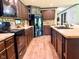 Well-equipped kitchen with dark cabinets, modern appliances, and wood flooring at 5010 S 550 W, Columbus, IN 47201