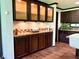 Kitchen featuring dark cabinets, granite countertop and tiled backsplash at 5010 S 550 W, Columbus, IN 47201