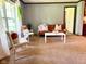 Sun-filled living room with neutral carpet, modern furnishings, and soft, natural light from a nearby window at 5010 S 550 W, Columbus, IN 47201