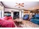 Cozy living room featuring comfortable seating, a ceiling fan, and a large television at 5010 S 550 W, Columbus, IN 47201