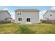 Backyard featuring a grassy lawn and a sliding glass door leading to the home's interior at 5520 N Woodside Ct, McCordsville, IN 46055