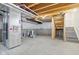 Unfinished basement space ready for customization, including a staircase and various mechanical components at 5520 N Woodside Ct, McCordsville, IN 46055
