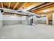 Unfinished basement with exposed beams and concrete walls, offering potential for customization and extra living space at 5520 N Woodside Ct, McCordsville, IN 46055