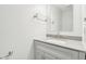 A well-lit bathroom featuring a single sink vanity, a mirror, and modern chrome fixtures at 5520 N Woodside Ct, McCordsville, IN 46055
