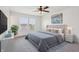 Bright bedroom featuring a tufted headboard bed, ceiling fan, and lots of natural light at 5520 N Woodside Ct, McCordsville, IN 46055