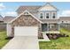 Charming two-story home with a brick facade and well-maintained landscaping, showcasing a welcoming curb appeal at 5520 N Woodside Ct, McCordsville, IN 46055