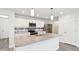 Well-lit kitchen featuring stainless steel appliances, quartz countertops, and ample cabinet space, blending style and functionality at 5520 N Woodside Ct, McCordsville, IN 46055