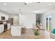 Bright kitchen and dining area, stainless steel appliances, and wood look floors create an inviting and modern space at 5520 N Woodside Ct, McCordsville, IN 46055