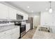 Modern kitchen featuring stainless steel appliances, quartz countertops, subway tile backsplash, and wood look flooring at 5520 N Woodside Ct, McCordsville, IN 46055