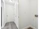 A clean mudroom with gray flooring, leading to the front door and a laundry area with hookups at 5520 N Woodside Ct, McCordsville, IN 46055