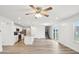 Bright, open floorplan featuring wood look floors, kitchen with island and stainless appliances, and stairs to second floor at 5520 N Woodside Ct, McCordsville, IN 46055