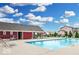Community pool with lounge chairs and nearby seating areas at 5520 N Woodside Ct, McCordsville, IN 46055