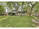 Beautiful home with a large, lush green backyard shaded by mature trees at 569 King Dr, Indianapolis, IN 46260