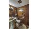 Wood-paneled bathroom with vintage fixtures at 569 King Dr, Indianapolis, IN 46260