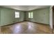 Spacious bedroom featuring hardwood floors, natural light and light green walls at 569 King Dr, Indianapolis, IN 46260