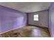Bedroom featuring hardwood floors, natural light and purple accent wall at 569 King Dr, Indianapolis, IN 46260