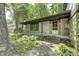 Charming covered front porch with stone facade and lush landscaping at 569 King Dr, Indianapolis, IN 46260