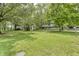 Expansive front yard with mature trees surrounding a two-story house at 569 King Dr, Indianapolis, IN 46260