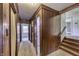Wood-paneled hallway with doorways leading to other rooms and carpet flooring at 569 King Dr, Indianapolis, IN 46260