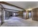 Open-concept living room with stone fireplace and doors leading to screened in porch at 569 King Dr, Indianapolis, IN 46260