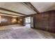 Large living room with doors leading to screened-in porch; wood paneling and beams at 569 King Dr, Indianapolis, IN 46260