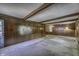 Large living room featuring wood paneling and beamed ceilings at 569 King Dr, Indianapolis, IN 46260