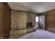 Stone fireplace with raised hearth and door to screened in porch at 569 King Dr, Indianapolis, IN 46260