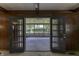 View of the screen-in porch through open french doors from the den at 569 King Dr, Indianapolis, IN 46260