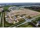 An aerial view displays a community in progress, some homes completed and others under construction at 5908 Agogo Way, Greenwood, IN 46143