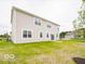 Expansive backyard featuring a well-maintained lawn and a view of the home's rear exterior at 5908 Agogo Way, Greenwood, IN 46143