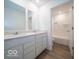 Modern bathroom with double vanity, two mirrors, and a tiled shower and bath at 5908 Agogo Way, Greenwood, IN 46143