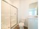 Well-lit bathroom featuring a glass-enclosed shower and modern vanity with sink at 5908 Agogo Way, Greenwood, IN 46143