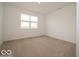 Bedroom with neutral carpet and a large window, offering a cozy and bright space at 5908 Agogo Way, Greenwood, IN 46143
