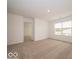 Bright bedroom featuring a large window, neutral walls, and plush carpeting at 5908 Agogo Way, Greenwood, IN 46143