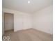 Bright bedroom featuring neutral carpet, closet and an ensuite bathroom at 5908 Agogo Way, Greenwood, IN 46143