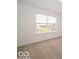 Neutral carpeted bedroom with a large window providing plenty of natural light at 5908 Agogo Way, Greenwood, IN 46143