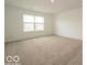 Bright bedroom featuring a large window, neutral walls, and plush carpeting at 5908 Agogo Way, Greenwood, IN 46143
