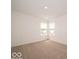 Carpeted bedroom featuring large windows and ample natural light throughout at 5908 Agogo Way, Greenwood, IN 46143