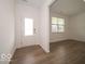 Bright entryway with hardwood floors and a view of a window with blinds at 5908 Agogo Way, Greenwood, IN 46143